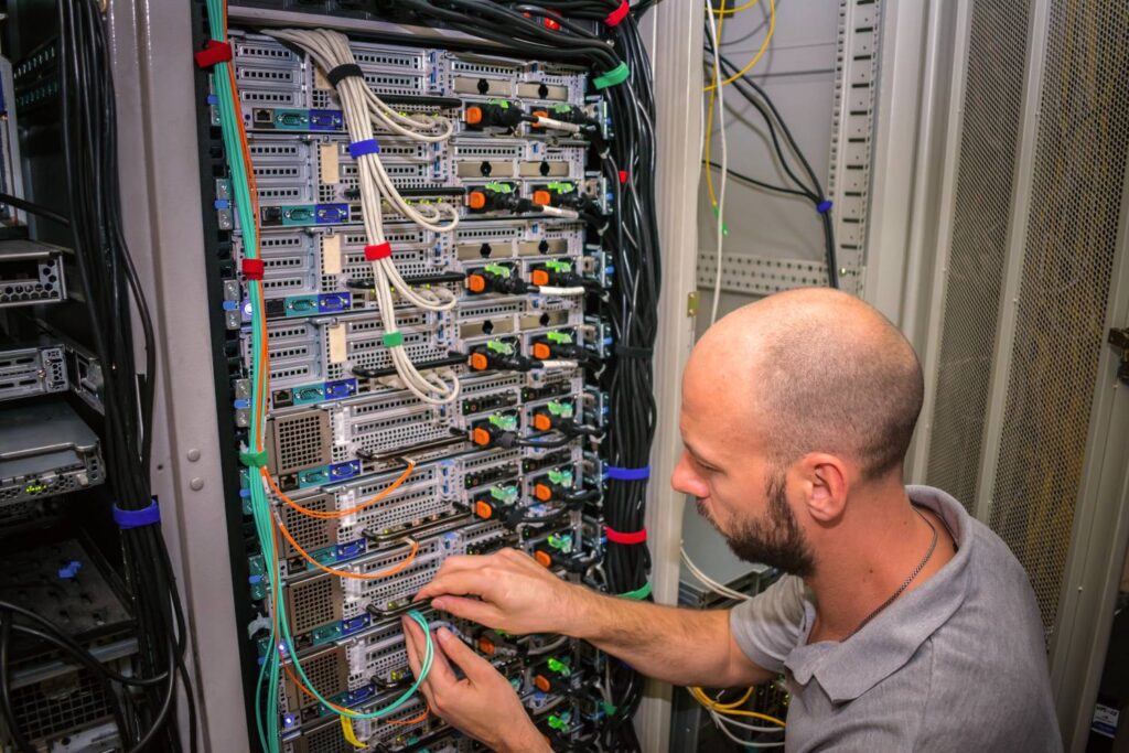 Emergency cabling repair in Oxnard, CA showing a technician quickly diagnosing and fixing damaged network cables to restore connectivity in a commercial facility.