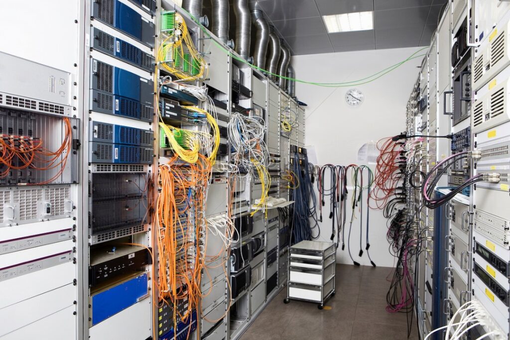 Data center server room in Oxnard, CA with extensive cable management, network switches, and servers—highlighting the need for professional wire organization in IT infrastructure installations.